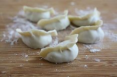 some dumplings are sitting on a wooden table