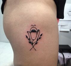 a woman's thigh with an arrow tattoo on it