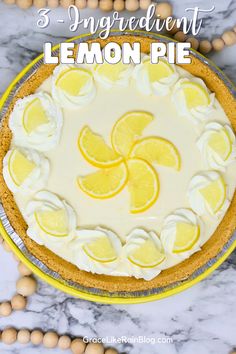 a lemon pie with white frosting and sliced lemons on top, surrounded by beads