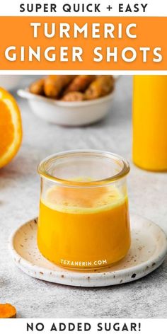 a glass jar filled with orange juice next to some sliced oranges on a plate