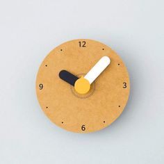 a yellow clock with black and white hands