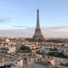 the eiffel tower towering over all of the buildings in paris, france at sunset