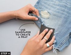 a woman's hands removing the fabric from her jean shorts