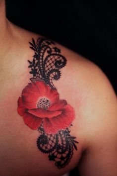 a woman's shoulder with a red flower tattoo on the left side of her chest