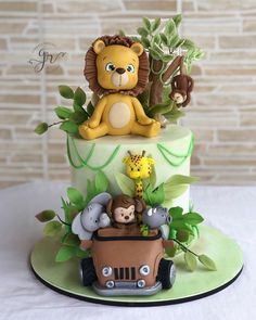 a birthday cake decorated with animals and a lion