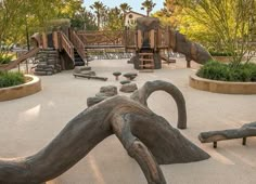 an outdoor play area with trees and rocks