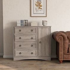 a brown chair sitting next to a wooden dresser