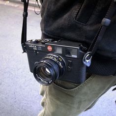 a man holding a camera in his pocket