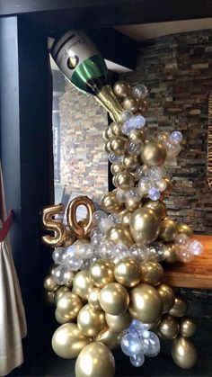 a christmas tree made out of balloons and streamers with the number 50 on it