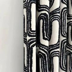 black and white curtains hanging on the wall