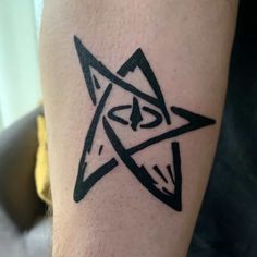 a black and white tattoo on the leg of a person with a star in it