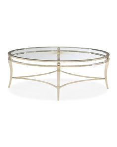 an oval glass coffee table with metal frame and gold accents on the top, against a white background