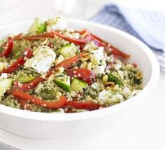 a white bowl filled with vegetables and feta cheese