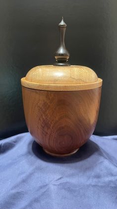 a wooden bowl sitting on top of a blue cloth