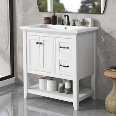 a white bathroom sink sitting under a mirror