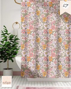 a bathroom with a flower shower curtain next to a potted plant