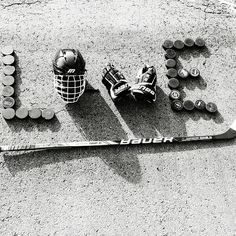 a hockey goalie's helmet, gloves and balls are laid out on the ground