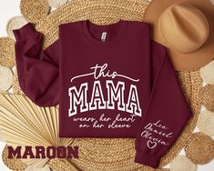 This Mama Wears Her Heart On Her Sleeve Sweatshirt for Mothers Day, Mother Day Gift for Mom, Custom Mama Sweater with kids Name on Sleeve While our standard processing time falls within 1 to 2 business days, you can count on us to have your shirt printed on the same day of your order placement. The sweatshirts and hoodies are cotton/poly mixed.  We employ DTF printing to craft vibrant designs, which are then expertly pressed onto our shirts, ensuring top-notch quality and long-lasting wear. --- Mama Sweaters, Mama Sweater, Mother Day Gift, Dtf Printing, Heart On, Cricut Ideas, Kid Names, Gift For Mom, Mother's Day Gifts