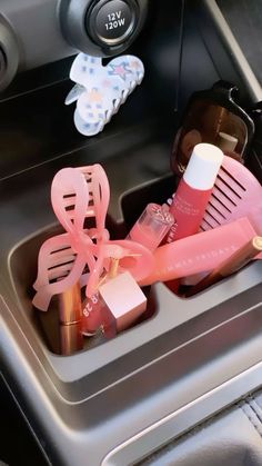 the interior of a car with various items in it, including hairbrushes and sunglasses