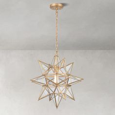 a golden star light hanging from the ceiling