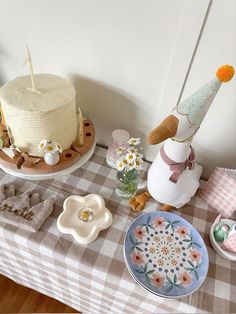 a table topped with plates and cakes covered in frosting