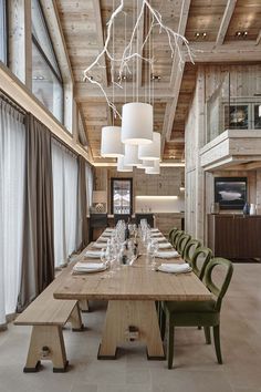 a long table with green chairs in a large room