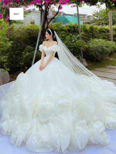 a woman in a wedding dress is posing for the camera