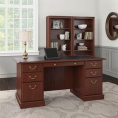 an office desk with bookshelves and drawers