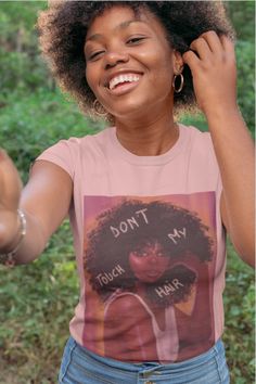 a woman wearing a t - shirt that says, don't touch my hair