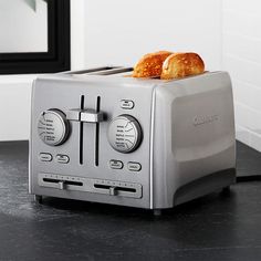 two croissants sitting on top of a toaster