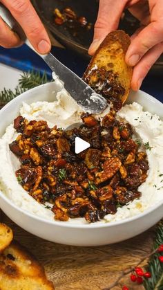 two hands holding a knife over a bowl filled with mashed potatoes and raisins