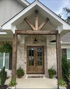 the front entrance to a house with two doors