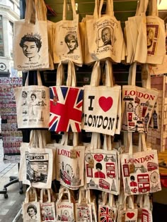 totes hanging up on the wall with i love london images and pictures printed on them