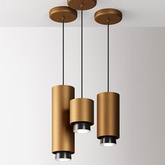 three lights are hanging from the ceiling in a room with white walls and flooring