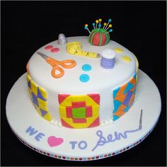 a birthday cake decorated with sewing supplies