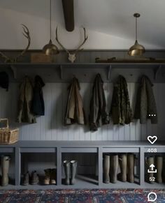 the coat rack is filled with coats and boots