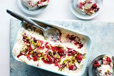 an ice cream dish with strawberries and pistachio