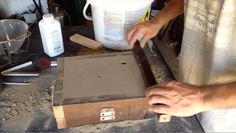 a man is working on some kind of object in the process of making something out of cardboard