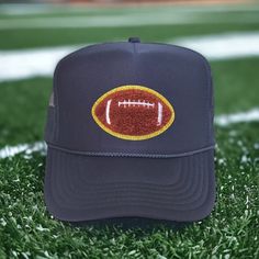 a football hat sitting on top of a green field