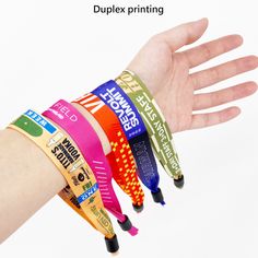 a person's hand with four different colored wristbands on it and the text, duplex printing