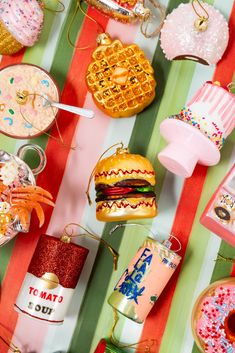 a table topped with lots of different types of donuts and other items on top of it