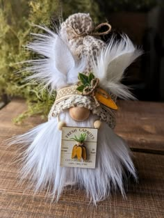 a doll with feathers and a tag on it