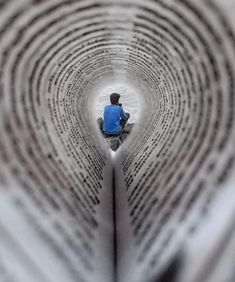 a person sitting in the middle of a book