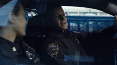 a police officer sitting in the back seat of a car