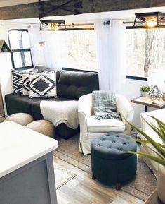 a living room filled with furniture and a potted plant on top of a table