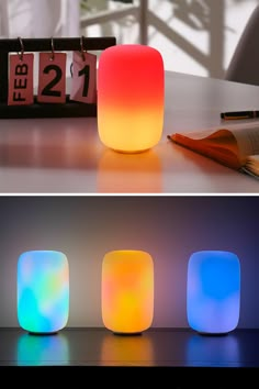 three different colored lights sitting on top of a table