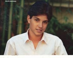 a young man in a white shirt posing for a photo