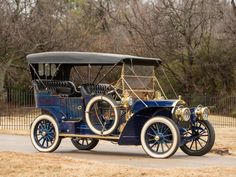 an antique car is parked on the side of the road