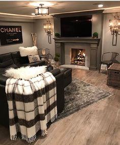 a living room filled with furniture and a fire place in the middle of the room