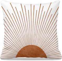 an orange and white pillow with sunbursts in the middle, on a white background